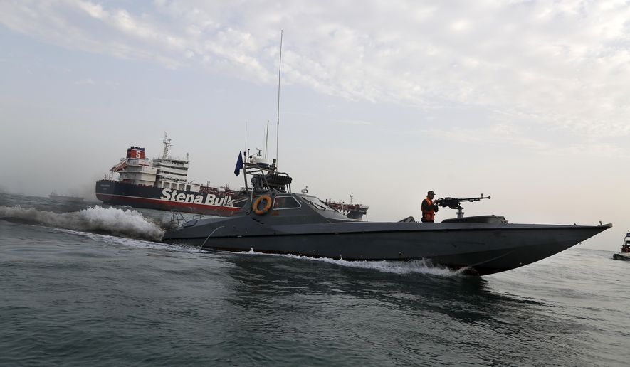 FILE - In this July 21, 2019 file photo, a speedboat of the Iran&#39;s Revolutionary Guard moves around a British-flagged oil tanker, the Stena Impero, which was seized by the Guard, in the Iranian port of Bandar Abbas. The U.S. Navy is trying to put together a new coalition of nations to counter what it sees as a renewed maritime threat from Iran. Meanwhile, Iran finds itself backed into a corner and ready for a possible conflict. It stands poised on Friday, Sept. 6, 2019, to further break the terms of its 2015 nuclear deal with world powers. (Hasan Shirvani/Mizan News Agency via AP, File)