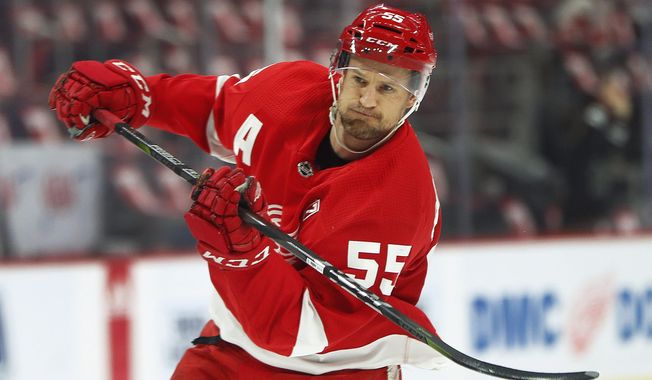 FILE - In this March 7, 2019, file photo, Detroit Red Wings defenseman Niklas Kronwall shoots during warmups before an NHL hockey game against the New York Rangers in Detroit. Kronwall is retiring after 15 seasons with the Red Wings. The hard-hitting defenseman announced his retirement in a video Tuesday, Sept. 3, on the team’s Twitter account. He’ll remain with the Red Wings as an adviser to the general manager. (AP Photo/Paul Sancya, File)