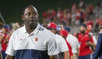 Syracuse coach Dino Babers looks at the scoreboard after the team&#39;s win over Liberty during an NCAA college football game in Lynchburg, Va., Saturday, Aug. 31, 2019. (AP Photo/Matt Bell)