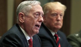 FILE - In this Oct. 23, 2018 file photo, Defense Secretary Jim Mattis speaks beside President Donald Trump, during a briefing with senior military leaders in the Cabinet Room at the White House in Washington. In Trump’s America, is anyone listening to the conservative wise men who damn him with faint, coded criticism? (AP Photo/Manuel Balce Ceneta, File)