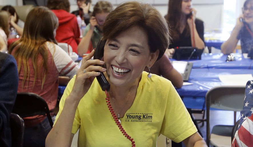 Young Kim, left, the Republican candidate for the 39th Congressional District in California, smiles as a bell rings at her headquarters in Yorba Linda, Calif., Tuesday, Nov. 6, 2018. (AP Photo/Alex Gallardo) ** FILE **
