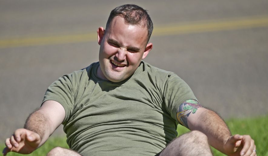 In a Wednesday, Oct. 16, 2013, photo, an overweight U.S. Navy sailor voluntarily participating in the U.S. Marines&#39; body composition program struggles doing sit-ups during a workout at the Marine Corps Recruit Depot in San Diego. Some service members have complained that the Defense Department&#39;s method of estimating body fat, known as the &quot;tape test,&quot; weeds out not just flabby physiques but bulkier, muscular builds. Fitness experts agree, saying the Pentagon&#39;s weight tables are outdated and do not reflect that Americans are now bigger, though not necessarily less healthy. (AP Photo/Lenny Ignelzi) **FILE**