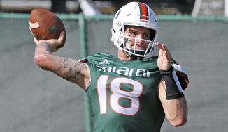 FILE - In this Aug. 7, 2019, file photo, Miami quarterback Tate Martell (18) throws the ball during an NCAA college football practice in Coral Gables, Fla. The vast majority of graduate transfers came through the transfer portal without much issue. A few underclassmen received waivers from the NCAA to play right away. Others must spend a season on the sideline after the governing body denied their requests. (Charles Trainor Jr./Miami Herald via AP, File)