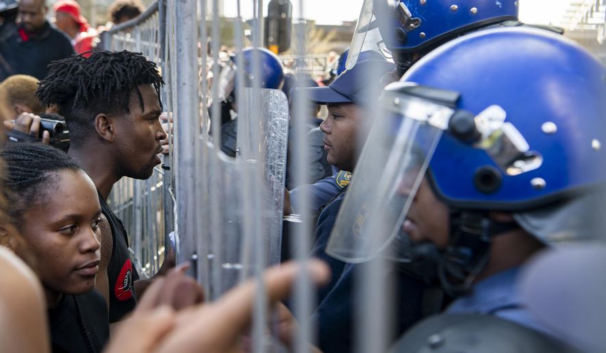 Demonstrators confront police in an attempt to gain entry to where the World Economic Forum on Africa is being held in Cape Town, South Africa, Wednesday, Sept. 4, 2019. The protesters are demanding that the government crack down on gender-based violence, following a week of brutal murders of young South African women that has shaken the nation. (AP Photo)