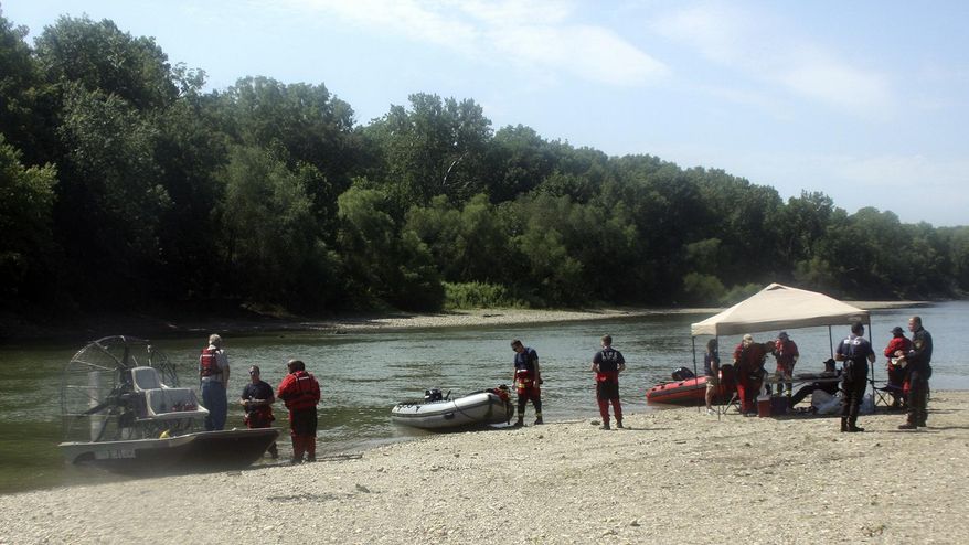 In this Tuesday, Sept. 3, 2019, photoair boats and pontoons use a sandbar on the White River as their temporary landing as they search for the final victim of Monday night's boating accident near Martinsville, Ind. Authorities will continue searching for a man missing since a Labor Day boating accident on a central Indiana river that left several people dead, including a 6-year-old boy. (Keith Rhoades/The Herald-Times via AP)