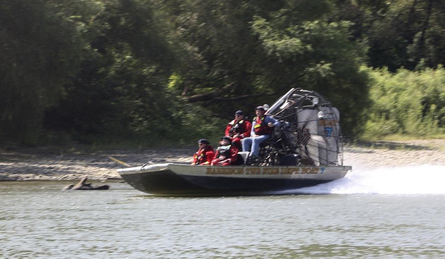 In this Tuesday, Sept. 3, 2019, photo an air boat from Harrison Township Fire Department makes its way up river as part of the search effort to recover the final victim of the boating accident near Martinsville, Ind. Authorities will continue searching for a man missing since a Labor Day boating accident on a central Indiana river that left several people dead, including a 6-year-old boy. (Keith Rhoades/The Herald-Times via AP)