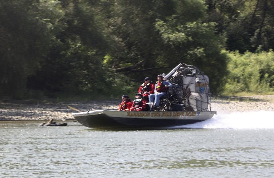 In this Tuesday, Sept. 3, 2019, photo an air boat from Harrison Township Fire Department makes its way up river as part of the search effort to recover the final victim of the boating accident near Martinsville, Ind. Authorities will continue searching for a man missing since a Labor Day boating accident on a central Indiana river that left several people dead, including a 6-year-old boy. (Keith Rhoades/The Herald-Times via AP)