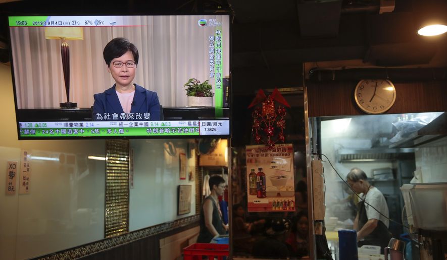 Hong Kong Chief Executive Carrie Lam makes an announcement on an extradition bill in television message, seen at a restaurant in Hong Kong, on Wednesday, Sept. 4, 2019. Hong Kong Chief Executive Lam has announced the government will formally withdraw an extradition bill that has sparked months of demonstrations in the city, bowing to one of the protesters' demands. The bill would have allowed Hong Kong residents to be sent to mainland China for trials. It sparked massive protests that have become increasingly violent and caused the airport to shut down earlier this month.(AP Photo/Jae C. Hong)