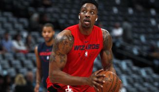 FILE - In this March 31, 2019, file photo, injured Washington Wizards center Dwight Howard practices before the Wizards face the Denver Nuggets in an NBA basketball game in Denver. Dwight Howard says he is returning to the Los Angeles Lakers with a new outlook on basketball and his place in it. Howard called it “a very big blessing” to re-sign with the Lakers, who chose him as the improbable replacement for injured center DeMarcus Cousins, Wednesday, Sept. 4, 2019. (AP Photo/David Zalubowski, File)