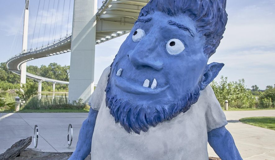 Omar the troll sits under the Bob Kerrey pedestrian bridge over the Missouri River after an unveiling ceremony in Omaha, Neb., Wednesday, Sept. 4, 2019. Omar, short for Omaha Metro Area River troll, is a painted bronze statue created by John Lajba. The city of Omaha hopes it's troll under the bridge will become a tourist attraction. (AP Photo/Nati Harnik)