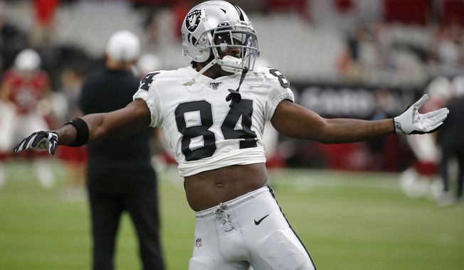 FILE - In this Aug. 15, 2019, file photo, Oakland Raiders wide receiver Antonio Brown (84) warms up for the team&#x27;s NFL preseason football game against the Arizona Cardinals, in Glendale, Ariz. Brown is part of a new receiving corps that will join a revamped offensive line led by Trent Brown and a first-round running in Josh Jacobs that could provide quarterback Derek Carr with his best supporting cast in six seasons in the NFL. (AP Photo/Rick Scuteri) ** FILE **