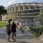 In this Aug. 5, 2017, file photo people make their way to RFK Stadium in Washington before an MLS soccer match between D.C. United and Toronto FC. The stadium, the former home of the NFL’s Washington Redskins, Major League Baseball’s Washington Nationals and Senators, and Major League Soccer’s D.C. United, will be demolished by 2021, local officials in Washington said. (AP Photo/Pablo Martinez Monsivais, File) **FILE**
