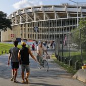 In this Aug. 5, 2017, file photo people make their way to RFK Stadium in Washington before an MLS soccer match between D.C. United and Toronto FC. The stadium, the former home of the NFL’s Washington Redskins, Major League Baseball’s Washington Nationals and Senators, and Major League Soccer’s D.C. United, will be demolished by 2021, local officials in Washington said. (AP Photo/Pablo Martinez Monsivais, File) **FILE**