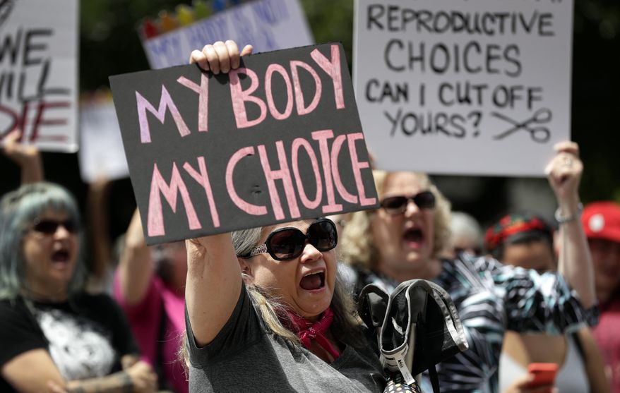 In this May 21, 2019, photo, a group gathers to protest abortion restrictions at the State Capitol in Austin, Texas. Arguments over a Texas law requiring that health care clinics bury or cremate fetal remains from abortions and miscarriages are set for a federal appeals court in New Orleans. A Texas judge blocked the law last year. U.S. District Judge David Ezra ruled that many clinics would be unable to meet the law’s requirements, thus creating unconstitutional obstacles for women seeking abortions. A three-judge panel of the 5th U.S. Circuit Court of Appeals hears arguments Thursday, Sept. 5.  (AP Photo/Eric Gay) **FILE**