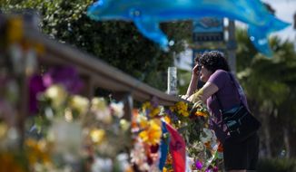 A woman gets emotional after placing flowers at a memorial for the victims of the Conception in the Santa Barbara Harbor on Wednesday, Sept. 4, 2019 in Santa Barbara, Calif. A fire raged through the boat carrying recreational scuba divers anchored near an island off the Southern California Coast on Monday, leaving multiple people dead. (AP Photo/Christian Monterrosa)