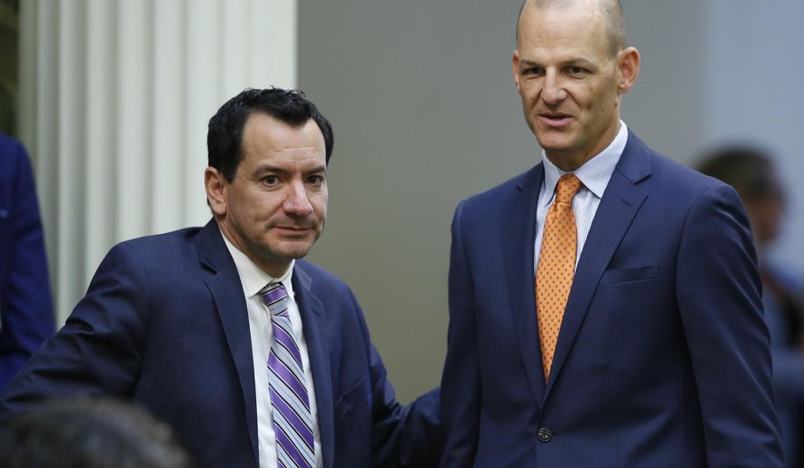 Assemblyman Kevin McCarty, D-Sacramento, right, talks with Assembly Speaker Anthony Rendon, D-Lakewood at the Capitol in Sacramento, Calif., Thursday, Sept. 5, 2019. The Assembly on Thursday approved putting McCarty's state constitutional amendment on the November 2020 ballot. If approved, it would allow convicted felons who are on parole the right to vote. The measure now goes to the Senate. (AP Photo/Rich Pedroncelli)