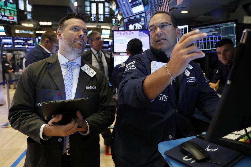 FILE - In this Aug. 19, 2019, file photo trader Frank Masiello, left, and specialist Anthony Matesic work on the floor of the New York Stock Exchange. The U.S. stock market opens at 9:30 a.m. EDT on Thursday, Sept. 5. (AP Photo/Richard Drew, File)