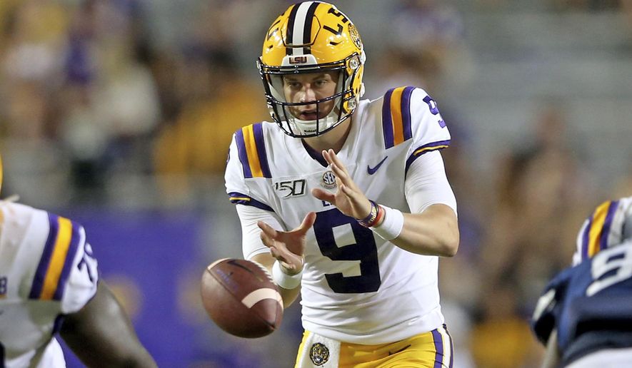 LSU quarterback Joe Burrow (9) takes a snap during the third quarter of the team's NCAA football game against Georgia Southern in Baton Rouge, La., Saturday, Aug. 31, 2019. Burrow tied an LSU single-game record with five touchdown passes before halftime. (AP Photo/Michael Democker)