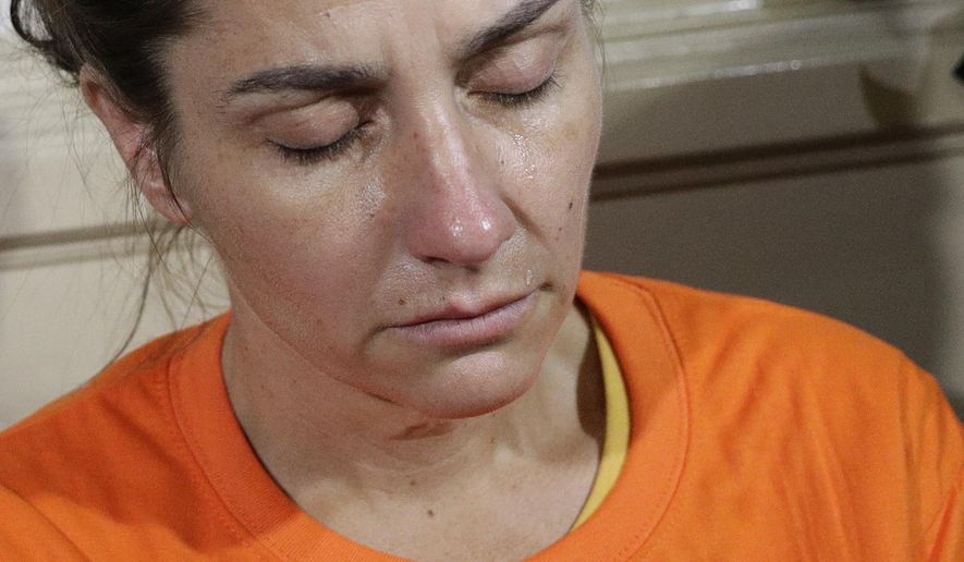 A tear rolls on the cheek of American national Jennifer Erin Talbot from Ohio before the start of a press conference by the National Bureau of Investigation (NBI) in Manila, Philippines, Thursday, Sept. 5, 2019. The NBI said that the 43-year-old Talbot was arrested at the Ninoy Aquino International Airport yesterday for trying to bring out of the country a 6-day old Filipino baby without proper travel documents. (AP Photo/Aaron Favila)