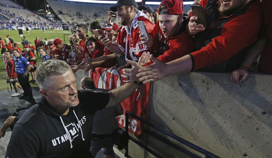 Utah head coach Kyle Whittingham greets fans after defeating BYU at an NCAA college football game, Thursday, Aug. 29, 2019, in Provo, Utah. Utah defeated BYU 30-12. (AP Photo/George Frey)