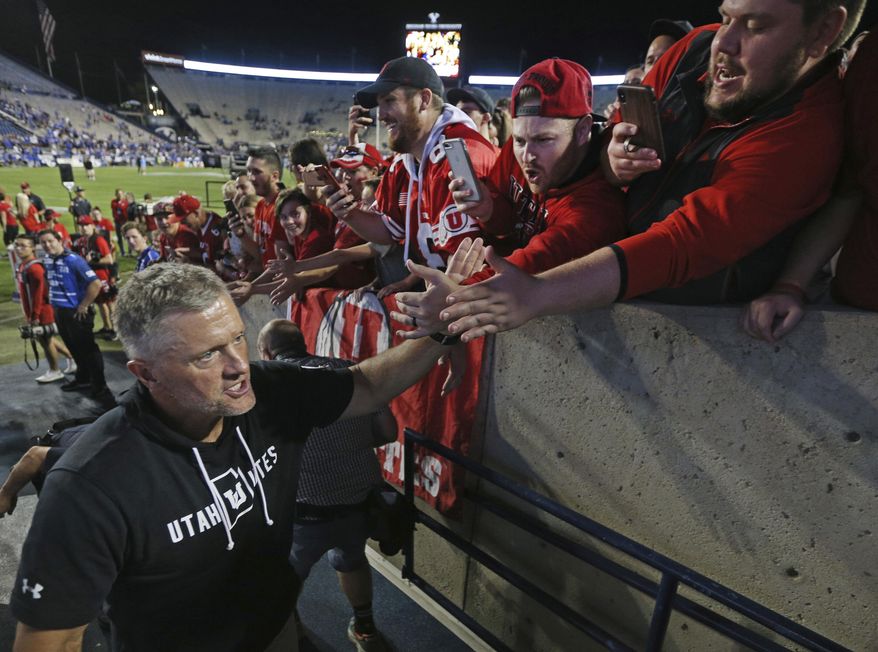 Utah head coach Kyle Whittingham greets fans after defeating BYU at an NCAA college football game, Thursday, Aug. 29, 2019, in Provo, Utah. Utah defeated BYU 30-12. (AP Photo/George Frey)