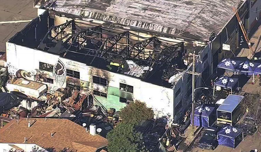 FILE - This Dec. 3, 2016, file image from video provided by KGO-TV shows the Ghost Ship Warehouse after a fire swept through the building in Oakland, Calif. A jury has decided the fate of two men charged with involuntary manslaughter after prosecutors say they turned a San Francisco Bay Area warehouse into a cluttered maze that trapped 36 partygoers during a fast-moving fire. The verdicts for Derick Almena and Max Harris will be announced Thursday, Sept. 5, 2019, after a three-month trial that drew family and friends of the victims to a packed courtroom, said Almena's attorney, Brian Getz. They face up to 39 years in prison if convicted. (KGO-TV via AP, File)