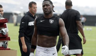 FILE - In this Aug. 20, 2019, file photo, Oakland Raiders&#39; Antonio Brown walks off the field after NFL football practice in Alameda, Calif. Coach Jon Gruden says star receiver Antonio Brown is back with the team and is expected to play the season opener on Monday, after a run-in with general manager Mike Mayock put him in jeopardy of being suspended. (AP Photo/Jeff Chiu, File)