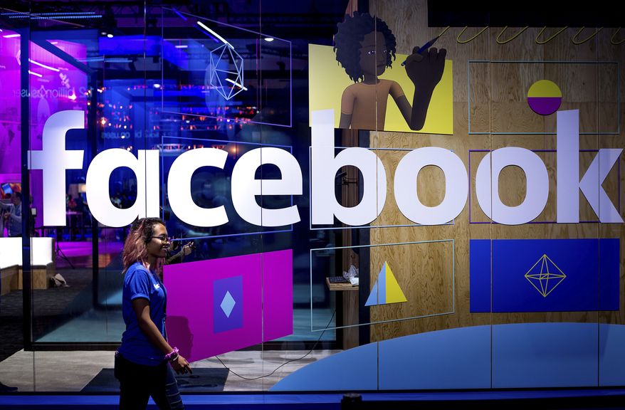 In this Tuesday, April 18, 2017, file photo, a conference worker passes a demo booth at Facebook's annual F8 developer conference, in San Jose, Calif. New York Attorney General Letitia James says a bipartisan coalition of state attorneys general is investigating Facebook for alleged antitrust issues. James said Friday, Sept. 6, 2019 the probe will look into whether Facebook's actions endangered consumer data, reduced the quality of consumers' choices or increased the price of advertising. (AP Photo/Noah Berger, File)