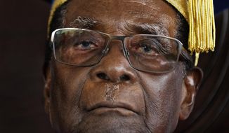 FILE -- In this Friday, Nov. 17, 2017 file photo, Zimbabwe&#39;s President Robert Mugabe officiates at a student graduation ceremony at Zimbabwe Open University on the outskirts of Harare, Zimbabwe. On Friday, Sept. 6, 2019, Zimbabwe President Emmerson Mnangagwa said his predecessor Robert Mugabe, age 95, has died.  (AP Photo/Ben Curtis, File)