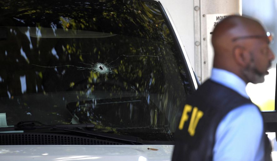 A bullet hole can be seen in the front window of a box truck where law enforcement officers where investigate after shots were fired involving Immigration and Customs Enforcement agents in the parking lot of a Food Lion store, Thursday, Sept. 5, 2019, in the Antioch neighborhood of Nashville, Tenn. An ICE agent opened fire in the grocery store parking lot early Thursday during an attempted apprehension, ICE spokesman Bryan Cox said. (Shelley Mays/The Tennessean via AP)
