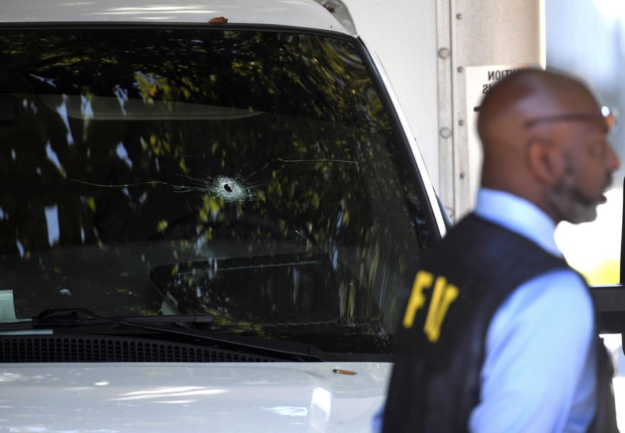 A bullet hole can be seen in the front window of a box truck where law enforcement officers where investigate after shots were fired involving Immigration and Customs Enforcement agents in the parking lot of a Food Lion store, Thursday, Sept. 5, 2019, in the Antioch neighborhood of Nashville, Tenn. An ICE agent opened fire in the grocery store parking lot early Thursday during an attempted apprehension, ICE spokesman Bryan Cox said. (Shelley Mays/The Tennessean via AP)