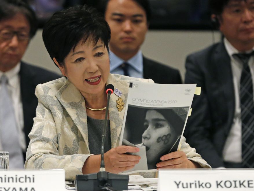 FILE - In this Nov. 29, 2016, file photo, Tokyo Gov. Yuriko Koike speaks at the IOC debriefing meeting in Tokyo. Japan wants to start using the traditional order for Japanese names in English in official documents, with family names first, a switch from the Westernized custom the country adopted more than a century ago. (AP Photo/Shuji Kajiyama, File)