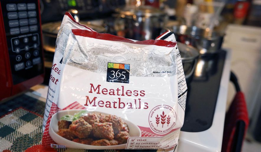 File-This July 2, 2019, file photo shows a bag of "meatless meatballs". Mississippi is considering new rules that let companies continue to use food-labeling terms such as “veggie burger” and “vegan bacon,” as long as the terms are prominently displayed so consumers understand the products are not meat. The state agriculture department on Thursday, Sept. 5, 2019, proposed new regulations for plant-based products that are sold as alternatives to meat. The regulations came in response to a lawsuit filed by a nonprofit organization advocating plant-based foods and an Illinois food company. The lawsuit was filed on July 1, the same day the state enacted a law dictating that "a plant-based or insect-based food product shall not be labeled as meat or a meat food product." (AP Photo/Rogelio V. Solis, File)