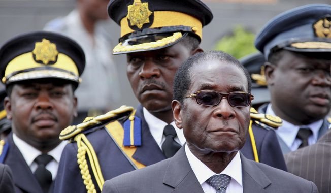 FILE - In this Saturday, Oct. 31, 2009, file photo Zimbabwe President Robert Mugabe arrives for the burial of a prominent member of his party, Misheck Chando, in Harare. On Friday, Sept. 6, 2019, Zimbabwe President Emmerson Mnangagwa said his predecessor Robert Mugabe, age 95, has died. (AP Photo/Tsvangirayi Mukwazhi, File)