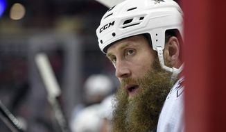 FILE - In this Dec. 4, 2017, file photo, San Jose Sharks center Joe Thornton (19) looks on from the bench during the first period of an NHL hockey game against the Washington Capitals in Washington. Thornton is coming back for another season at age 40, signing a one-year, $2 million contract with the  Sharks on Friday, Sept. 6, 2019, after briefly contemplating retirement at the end of this past season. (AP Photo/Nick Wass, File)