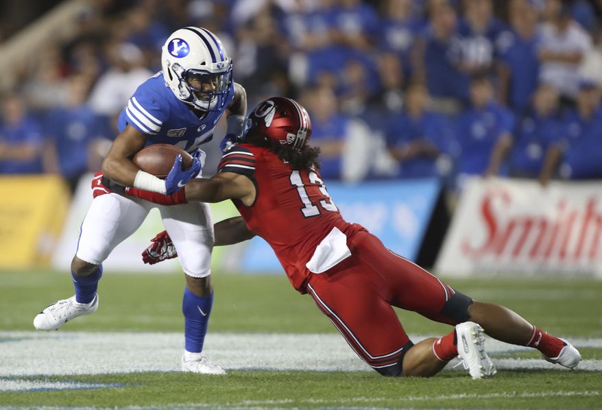 BYU wide receiver Aleva Hifo (15) is tackled by Utah linebacker Francis Bernard (13) during the first half during an NCAA college football game Thursday, Aug. 29, 2019, in Provo, Utah. (AP Photo/George Frey)