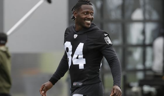 In this Aug. 20, 2019 file photo, Oakland Raiders&#39; Antonio Brown smiles before stretching during NFL football practice in Alameda, Calif.  Brown was released by the Raiders,  Saturday, Sept. 7, 2019.  (AP Photo/Jeff Chiu, File) **FILE**