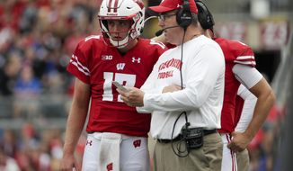 Wisconsin head coach Paul Chryst talks to quarterback Jack Coan during the first half of an NCAA college football game against Central Michigan Saturday, Sept. 7, 2019, in Madison, Wis. (AP Photo/Morry Gash)