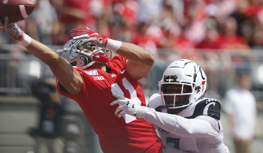 Cincinnati defensive back Coby Bryant, right, interferes with Ohio State receiver Austin Mack trying to catch a pass during the second half of an NCAA college football game Saturday, Sept. 7, 2019, in Columbus, Ohio. Bryant was penalized on the play. Ohio State beat Cincinnati 42-0. (AP Photo/Jay LaPrete)