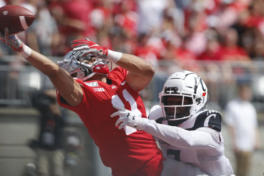 Cincinnati defensive back Coby Bryant, right, interferes with Ohio State receiver Austin Mack trying to catch a pass during the second half of an NCAA college football game Saturday, Sept. 7, 2019, in Columbus, Ohio. Bryant was penalized on the play. Ohio State beat Cincinnati 42-0. (AP Photo/Jay LaPrete)