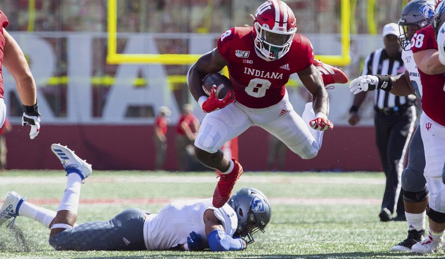 Indiana running back Stevie Scott III (8) is tripped up as he rushes the ball out of the backfield during the first half of an NCAA college football game against Easter Illinois, Saturday, Sept. 7, 2019, in Bloomington, Ind. (AP Photo/Doug McSchooler)