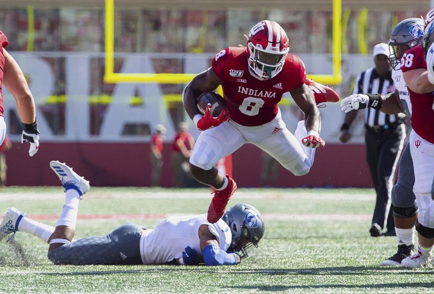 Indiana running back Stevie Scott III (8) is tripped up as he rushes the ball out of the backfield during the first half of an NCAA college football game against Easter Illinois, Saturday, Sept. 7, 2019, in Bloomington, Ind. (AP Photo/Doug McSchooler)