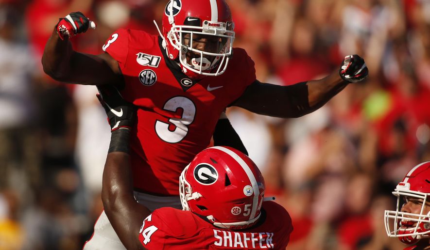 Georgia running back Zamir White (3) celebrates with offensive lineman Justin Shaffer (54) after scoring a touchdown in the first half of an NCAA college football game Saturday, Sept. 7, 2019, in Athens, Ga. (Joshua L. Jones/Athens Banner-Herald via AP)