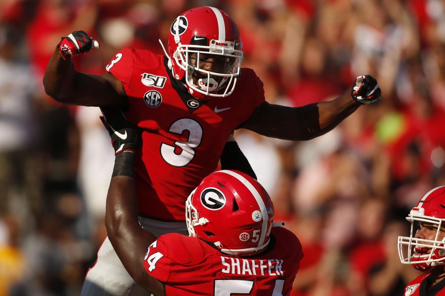 Georgia running back Zamir White (3) celebrates with offensive lineman Justin Shaffer (54) after scoring a touchdown in the first half of an NCAA college football game Saturday, Sept. 7, 2019, in Athens, Ga. (Joshua L. Jones/Athens Banner-Herald via AP)