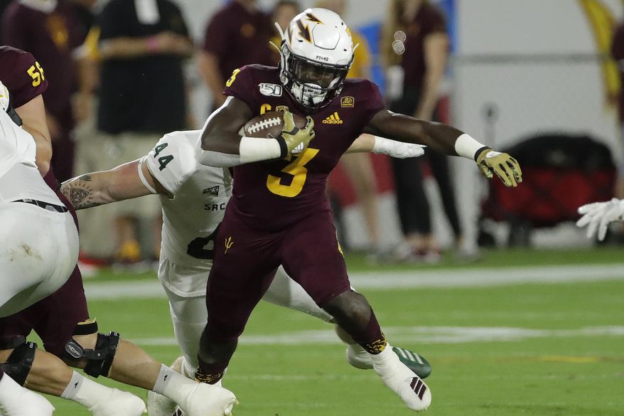 Arizona State running back Eno Benjamin (3) is chased down by Sacramento State defensive lineman Josiah Erickson (44) during the first half of an NCAA college football game Friday, Sept. 6, 2019, in Tempe, Ariz. (AP Photo/Matt York)