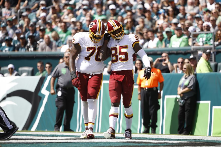 Washington Redskins' Vernon Davis, right, and Morgan Moses celebrate after Davis' touchdown during the first half of an NFL football game against the Philadelphia Eagles, Sunday, Sept. 8, 2019, in Philadelphia. (AP Photo/Matt Rourke)