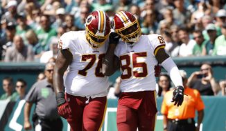Washington Redskins&#39; Vernon Davis, right, and Morgan Moses celebrate after Davis&#39; touchdown during the first half of an NFL football game against the Philadelphia Eagles, Sunday, Sept. 8, 2019, in Philadelphia. (AP Photo/Matt Rourke) ** FILE **