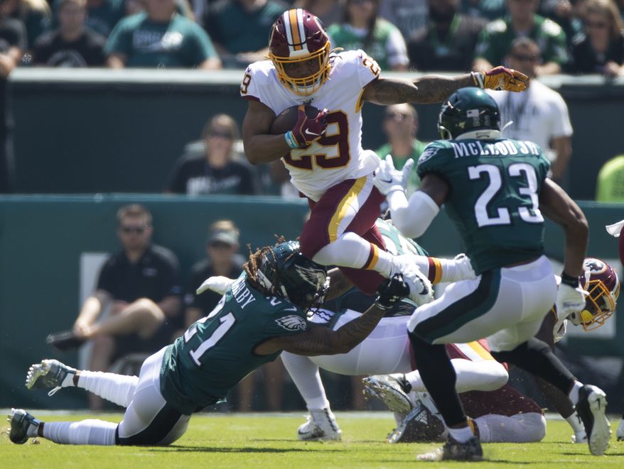 Washington Redskins running back Derrius Guice (29) jumps over Philadelphia Eagles cornerback Ronald Darby while carrying the football during an NFL football game, Sunday, Sept. 8, 2019, in Philadelphia, PA. (AP Photo/Jason E. Miczek) ** FILE **