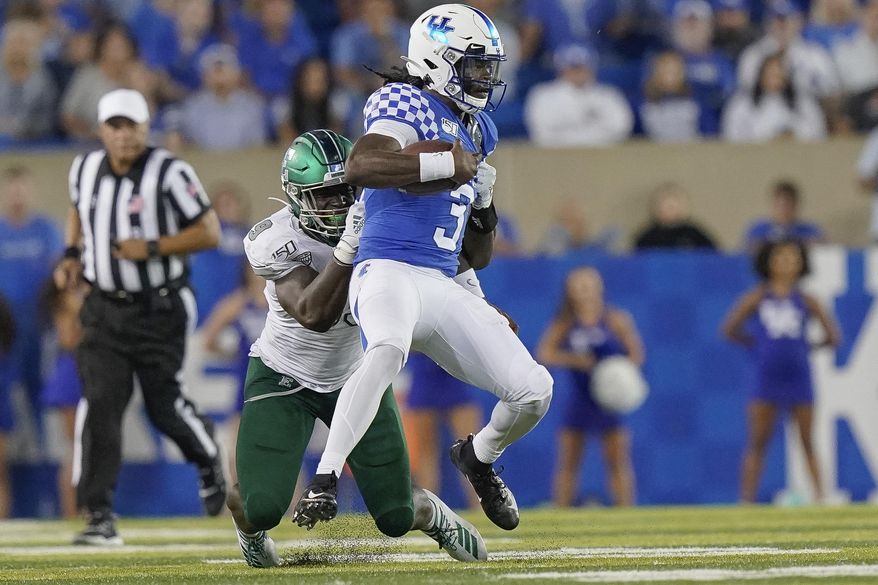 Kentucky quarterback Terry Wilson (3) is tackled by Eastern Michigan defensive lineman Turan Rush (99) during the second half of an NCAA college football game between Kentucky and Eastern Michigan, Saturday, Sept. 7, 2019, in Lexington, Ky. Wilson was injured and left the game on a cart as a result of the play. (AP Photo/Bryan Woolston)