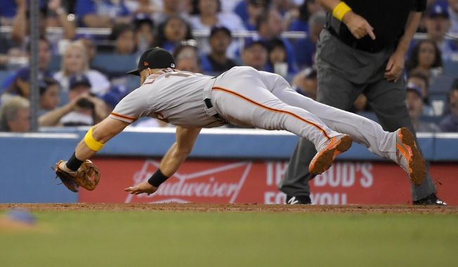 San Francisco Giants&#x27; Evan Longoria dives for a ground ball hit by Los Angeles Dodgers&#x27; Will Smith during the second inning of a baseball game Saturday, Sept. 7, 2019, in Los Angeles. Smith was safe at first on the play. (AP Photo/Mark J. Terrill)
